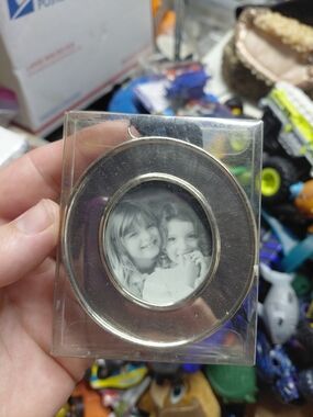 silver-toned circular picture frame 2"